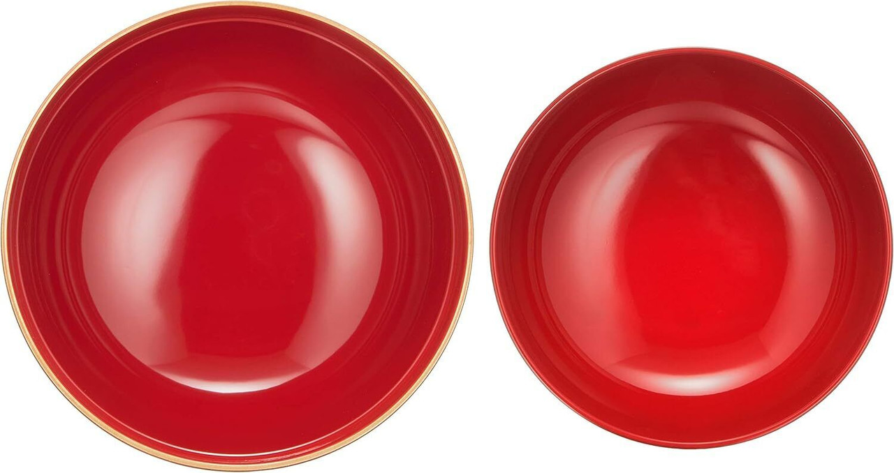 Two shallow red lacquered bowl interiors seen from directly above, side by side on a white ground