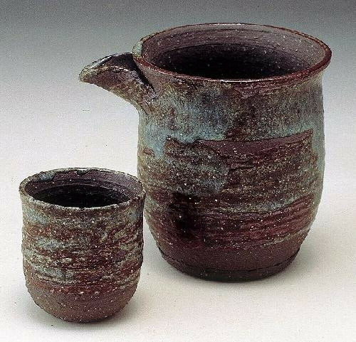 Shigaraki yaki sake set with tokkuri carafe and two guinomi cups in black gradation glaze with wabi-sabi texture