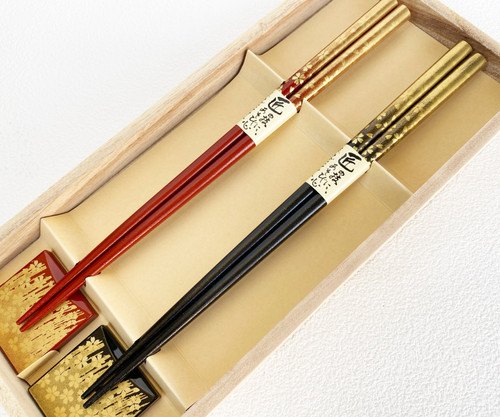 A Yamanaka lacquerware chopstick pair with gold sakura chopstick rests