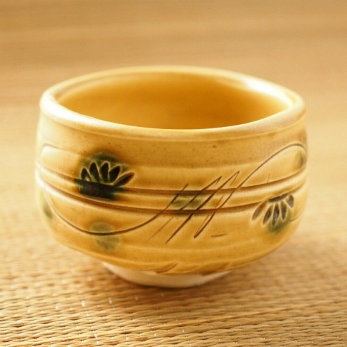 A Mino ware matcha tea bowl in the Yellow Seto (Kizeto) style — the soft, matte, oil-yellow glaze over a humble form