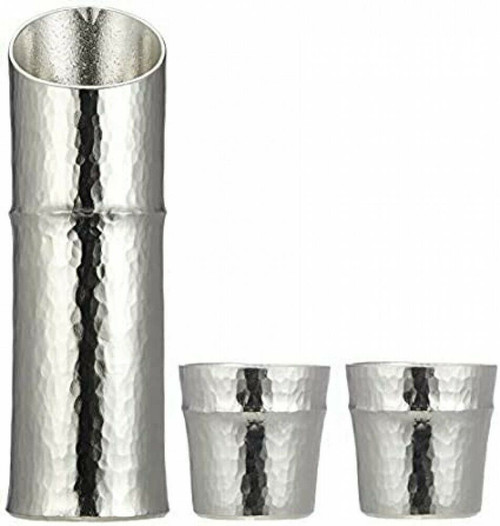 A hammered tin sake bottle and pair of tin cups from the Takaoka Nousaku workshop