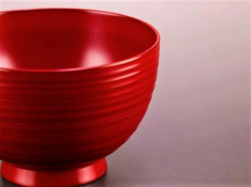 An Echizen lacquered wooden soup bowl in red with lateral stripes