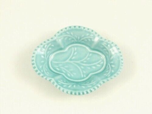 A small pale blue-green Arita dish in a lobed mokko shape