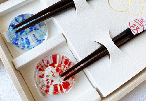 A boxed gift pair of Wakasa-nuri lacquered chopsticks with glass chopstick rests