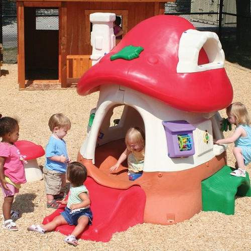 Mushroom Kottage with kids playing and wood chips surfacing