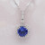 Tanzanite and diamond halo pendant