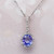 Tanzanite and diamond halo pendant