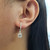 Emerald Cut Diamond Halo Dangle Earrings When Worn