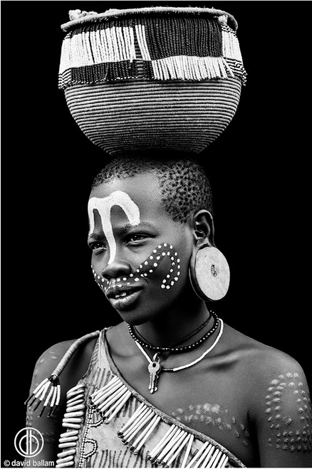 Man with Black and White Body Paint Wearing Feather Headdress