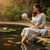 Woman relaxing before placing her Aquasphere Pro Biodegradable Pond Cleaner into her Koi Pond