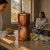 Sisters emjoy our Sertodo Sana Vida Ayurvedic Copper Gravity Water Filter as a hydration centerpiece in a mountain inspired kitchen.