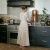 Woman enjoys her Sertodo Sana Vida Ayurvedic Copper Gravity Water Filter.