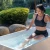 A woman practices her cold plunge therapy in our PULSE PolarSpa cold plunge tub. A simple outdoor routine, calm authority.