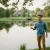 Man taking care of his suburban pond with our Aquasphere Pro