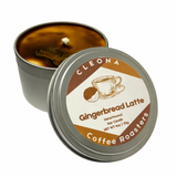 Gingerbread Latte soy candle by Raven Soul Elixir in a sleek metal tin, hand-poured in Lebanon, Pennsylvania. Part of the Coffeehouse Collection, this candle combines the cozy aromas of gingerbread and freshly brewed coffee. Displayed with ginger, brown sugar, and coffee beans to evoke a warm, seasonal café feel.