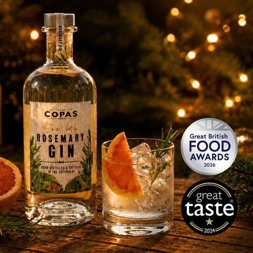 Bottle of Copas gin on a festive table with award badges
