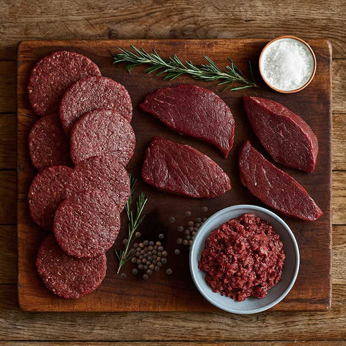 a selection of venison burgers, steaks and mince on a wooden board a selection of venison burgers, steaks and mince on a wooden board