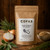 A brown paper packet on a wooden chopping board containing Copas Sage and Onion Gluten Free Stuffing