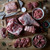 Uncooked Lamb Cuts laid out on a wooden surface Uncooked Lamb Cuts laid out on a wooden surface