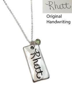 Large Rectangle Actual Handwriting Necklace .999 Fine Silver (PMC). Use Handwriting from Mom, Dad, or a Loved One. Handwriting or a Drawing of a Child could be used. Handwriting of a Passed Loved One would make a Perfect Memorial Piece. Shown on a Solid Sterling Silver Cable Chain. Choose from large selection of chains. Use the drop down menu to add Genuine Swarovski Birthstones. This piece has an organic look and will not be perfectly round or flat. Each piece has subtle surface variations.
 
Sterling Heart Songs Jewelry uses the highest quality PMC (Pure Metal Clay) with the strongest bonding metal available. .999 Fine Silver is almost Pure Silver and it starts out as a Metal Clay. We create a stamp of your exact image and stamp it into a Nice Thick Piece of Clay. The clay is then Kiln Fired, not hand fired like many other shops, for the strongest bond. It then turns into .999 Fine Silver Metal. It is Tumbled to make the metal even stronger and Hand Polished. Attention to detail is paid at every step while your piece is being created. The process of creating this piece is spanned out over multiple days. Production time for the Fine Silver Line of Jewelry takes around 3 weeks.
 
SIZE:
Approx. 1 1/2" x 3/4" .999 Fine Silver. Size will vary slightly based on the image submitted, but we adjust the image to best fit the desired size. 

HOW TO ORDER:
Please upload your image as you place your order. If you face technical issues or more than one image to upload, e-mail the image/s to info@sterlingheartsongs.com as an alternative. Make sure your scanned image is a clear picture taken straight on of the handwriting or drawing you will be using. The writing needs to be on plain white paper without patterns in the background. If it is on lined paper, it may be usable, please e-mail info@sterlingheartsongs.com first to be sure.