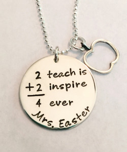 Teacher Necklace "2 Teach is 2 Inspire 4 Ever" Hand Stamped Math Saying, with optional Apple Outline Charm, all .925 Sterling Silver Necklace and choice of chain. It is shown with a Polished Finish on a Solid Sterling Silver Diamond Bead Chain. Choose from five custom finish options. Use the drop down menu to add Genuine Swarovski Birthstones.

SIZE:
Solid Sterling Silver 1" Round 
Solid Sterling Silver Apple Outline Charm Approx. .6"x.7"