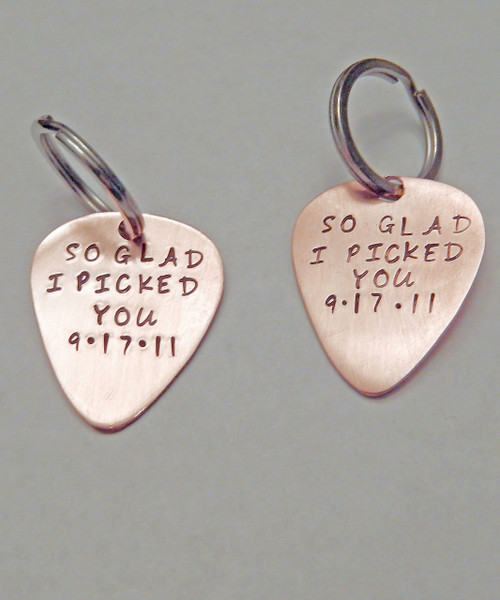 DESCRIPTION:
Set of Two "So Glad I Picked You" Wedding or Anniversary Hand Stamped Personalized Guitar Pick Key Chain Matching Set.They are shown in Solid Copper with a Brushed Finish on a stainless steel key rings. Guitar Picks in choice of Solid Nickel, Solid Copper, Solid Brass, or Solid Sterling Silver. Choose from five custom finishes. Optional Black Leather Cases. Double Sided Text Optional. 
 
SIZE:
Set of 1" x 1 3/16" Guitar Picks