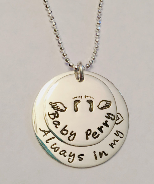 Stamped Infant Loss Necklace ~ Sterling Silver Child Memorial Necklace ~ "Always in my heart" Baby Feet & Angel Wings Remembrance Necklace. It is shown with a Polished Finish on a Diamond Cut Bead Chain. Choose from five custom finish options. You can have a Date or Name below the baby feet if you like, or customize the text on the larger piece of silver. Use the drop down menu to add Genuine Swarovski Birthstones.

SIZE:
Solid Sterling Silver 1" Round with "Always in my heart" or custom text
Solid Sterling Silver 3/4" Round with baby feet and angel wings (optional name, date, other custom text)