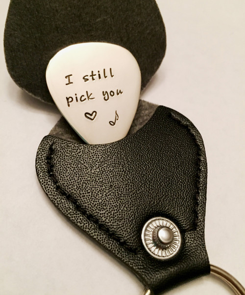 DESCRIPTION:
"I Still Pick You" Stamped Guitar Pick Key Chain with heart & music note with optional Black Leather Case. Shown with a Polished Finish in Solid Sterling Silver. Choose from five custom finish options. Choice of Solid Nickel, Solid Copper, Solid Brass, or Solid Sterling Silver. Double sided text optional. 
*AGED AND OXIDIZED HAMMERED ARE NOT AVAILABLE IN NICKEL.
 
SIZE:
1 1/4" x 1" Guitar Pick