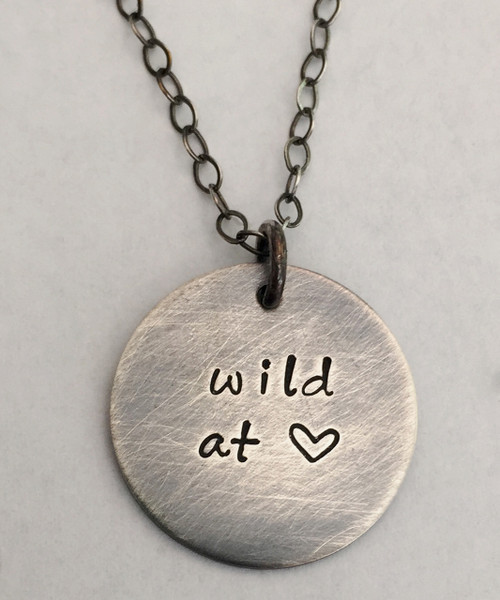 "wild at heart" Hand Stamped Sterling Silver Round Necklace and choice of chain. Choose from five custom finish options. It is shown with an Aged Finish on a Solid Sterling Silver Cable Chain with an Aged Finish as well. *Note- The chain will not come with an aged finish unless you choose one of the aged chains. Any sterling silver chain can be given an aged finish upon request; just leave notes when checking out that you would like your chain aged. Choose from five custom finish options. Use the drop down menu to add Genuine Swarovski Birthstones. This necklace is custom, personalized to your needs, and handmade with care.
 
SIZE: 
Solid Sterling Silver 5/8" Round