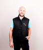 Features reverse coil zippers, a zippered chest pocket, and front zippered pockets.