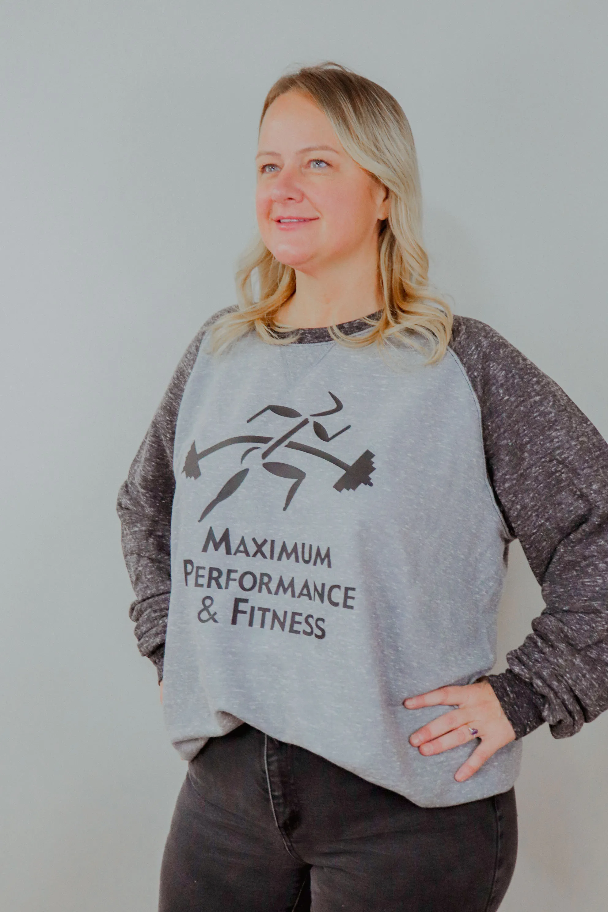 Woman wearing a Maximum Performance & Fitness crewneck