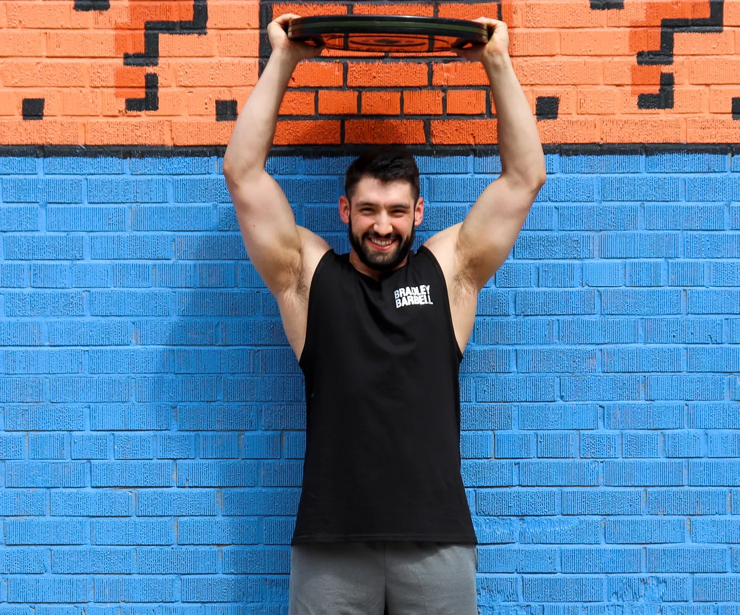 man holding weight plate