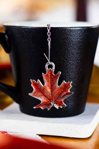 Maple Leaf tea infuser on black mug