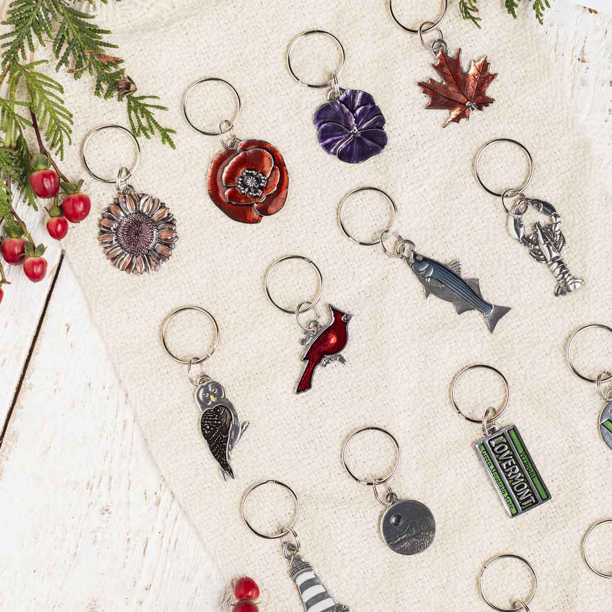a collection of keyring stocking stuffers in a flat lay on white