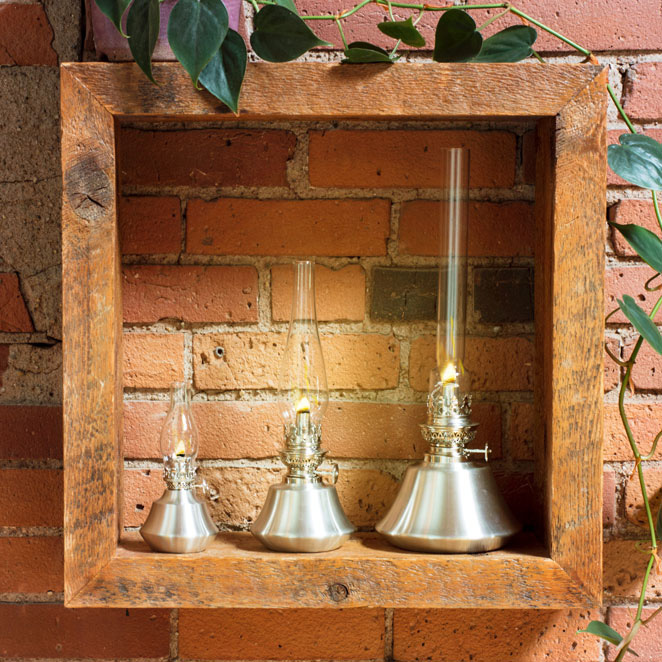3 oil lamps arranged against a wall