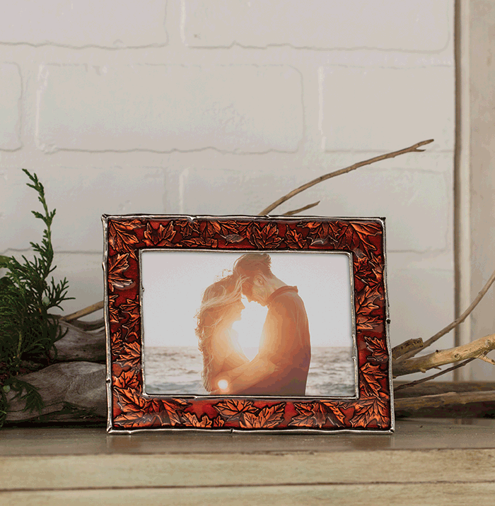 Engagement photo in an autumn maple leaf pattern photo frame