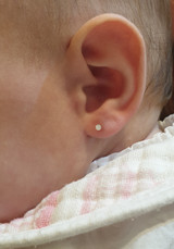 Natural Diamond Cluster Small Round Ear Stud in YG on babies ear lobe