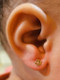 14k Flower with Pink Enamel set in Solid Yellow Gold on ear