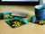 Marigold flower coaster set strewn across a wooden table, one bottom up, one with a teacup on it.