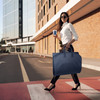 lifestyle image with person carrying a garment bag lifestyle image with person carrying a garment bag