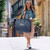 lifestyle image of woman carrying garment bag