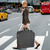lifestyle image person carrying garment bag