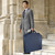 lifestyle showing someone carrying garment bag