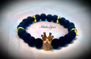 Black matte beads with gold tone spacers and crown.