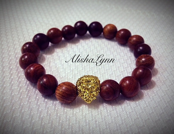 Wooden stretch bracelet with gold tone lion head.
