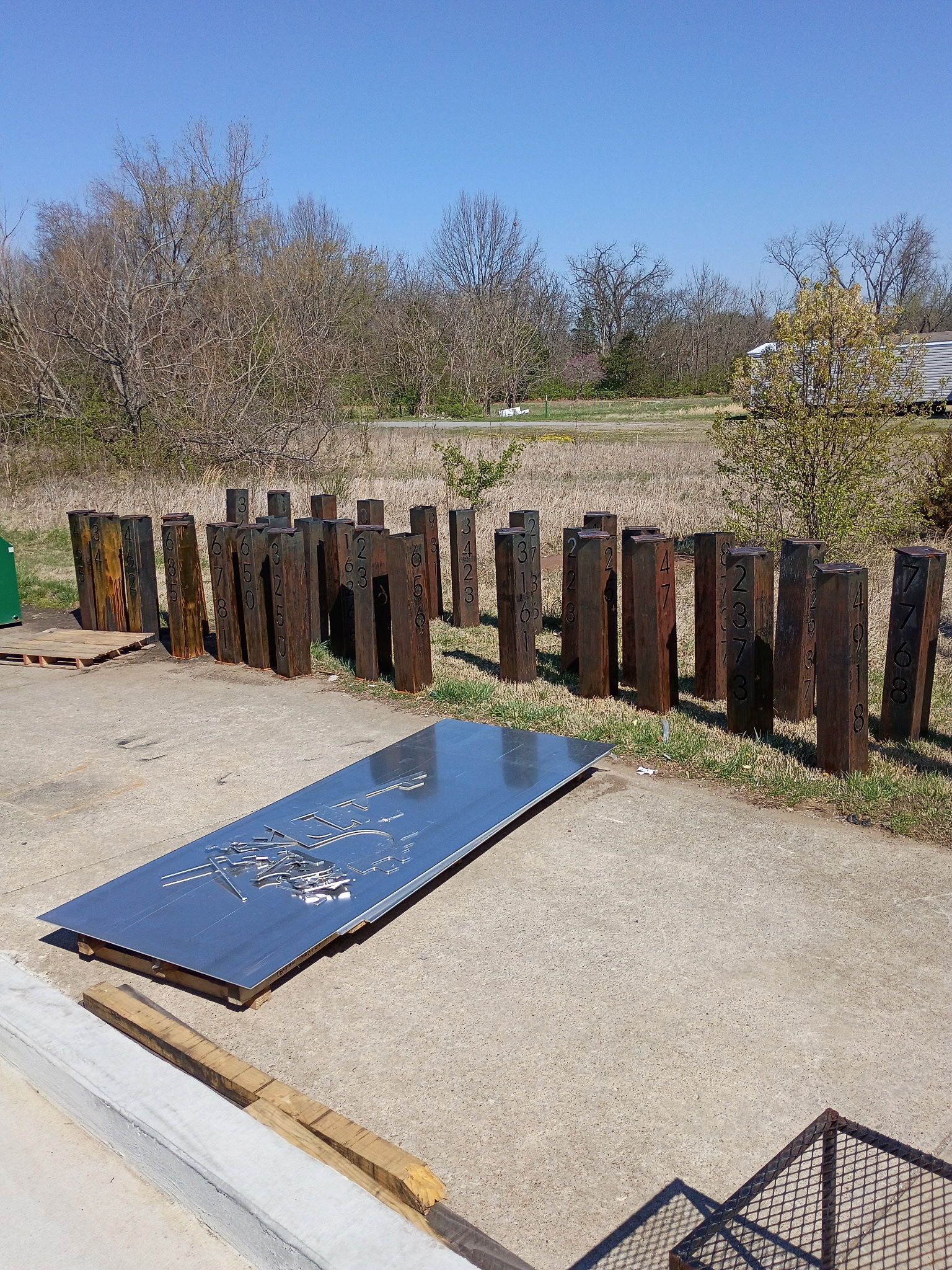 Raw steel address pillar weathering into a natural patina
