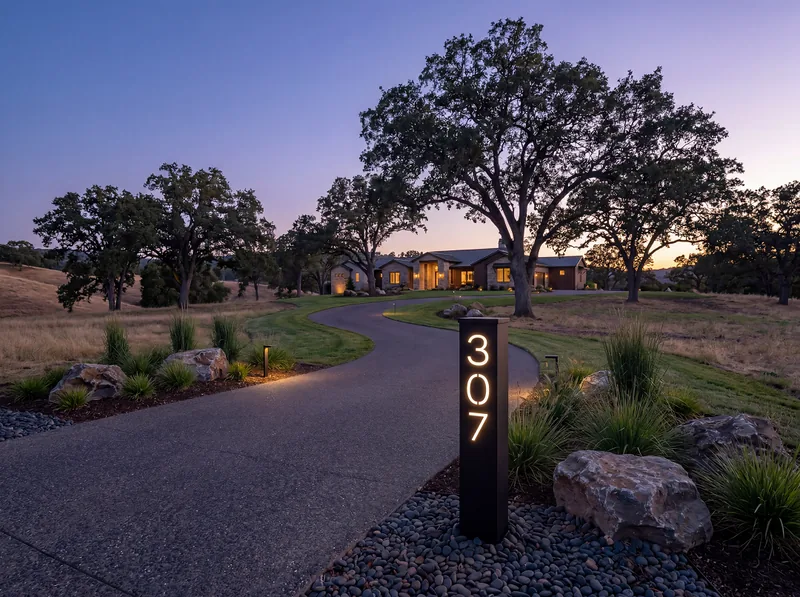 Solar address pillar glowing at night, clearly readable from the road