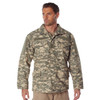 Rothco M-65 Field Jacket M65FJ, camouflage military-style jacket with multiple pockets and a rugged design worn by a male model. Thumbnail Image