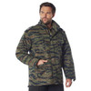 Rothco M-65 Field Jacket M65FJ, man wearing camouflage military-style field jacket with multiple pockets and a high collar. Thumbnail Image