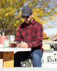 Iron & Haft Men’s Button Down Work Flannel, Men's red plaid work shirt with long sleeves and button front, outdoor casual setting.